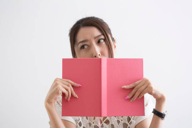 istock Women who hide their faces in books 1082019044