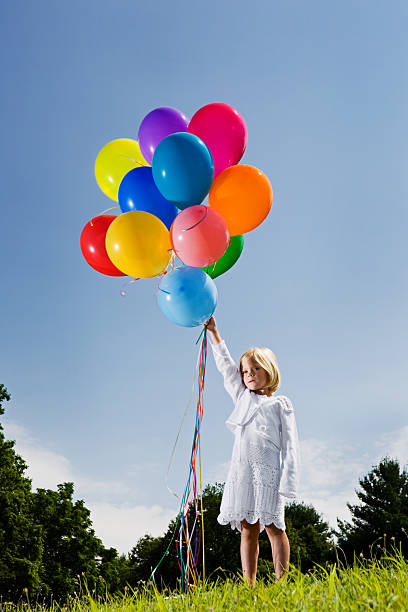 istock Little blond girl holds multicolored balloons 108201933