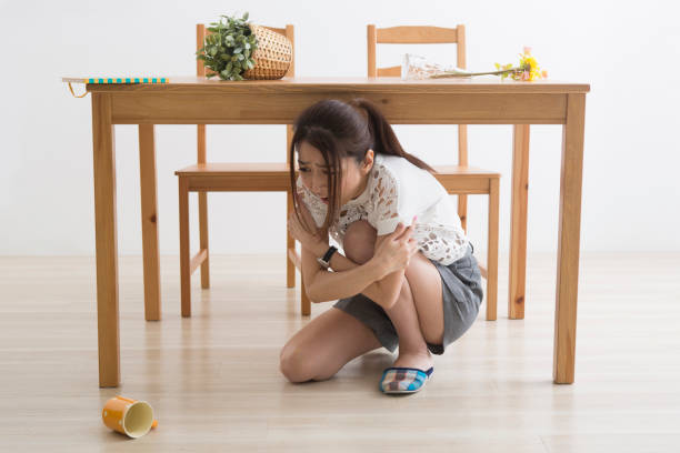 istock A woman displaced under the table by an earthquake 1082020182