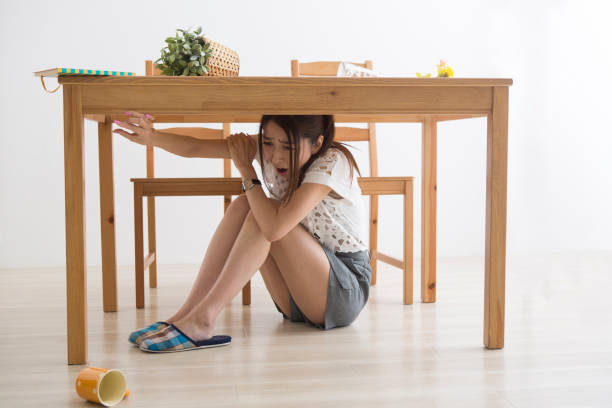 istock A woman displaced under the table by an earthquake 1082020264