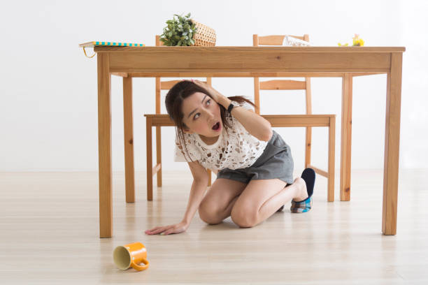 istock A woman displaced under the table by an earthquake 1082020290