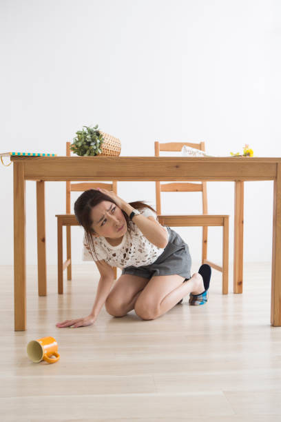 istock A woman displaced under the table by an earthquake 1082020298