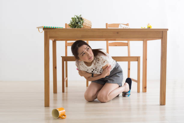 istock A woman displaced under the table by an earthquake 1082020324