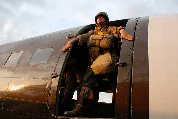 Stock photograph of US Paratroopers standing in the door of C-47 aircraft. 