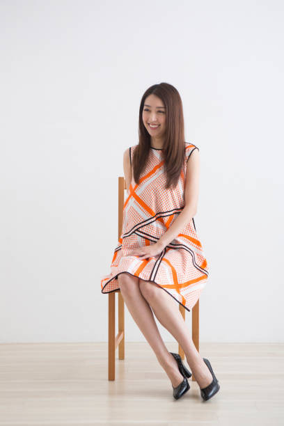 istock One piece woman sitting on a chair 1082020636