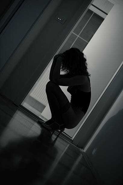 istock Sad Young Woman Kneeling on Floor, Low Key 108202091