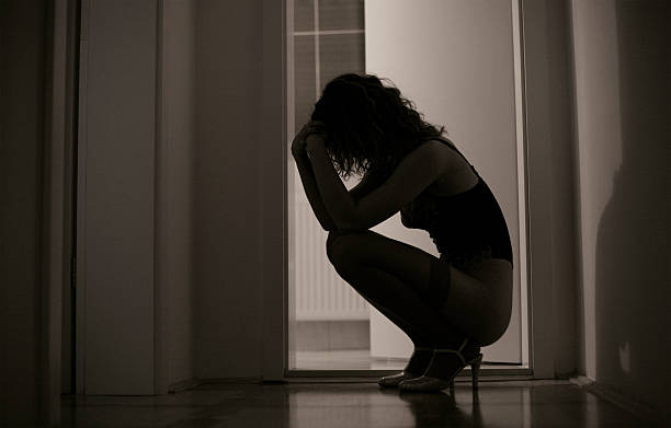 istock Sad Young Woman Kneeling on Floor, Low Key 108202095