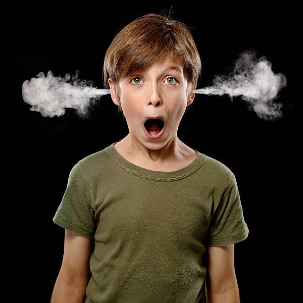 Little Boy with Steam Coming From Ears stock photo