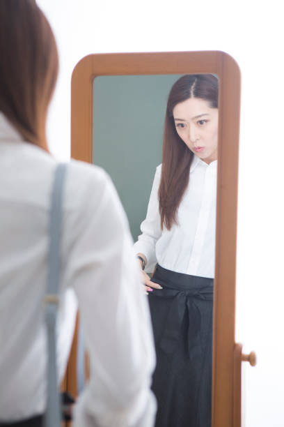 istock Woman looking in the mirror 1082021460