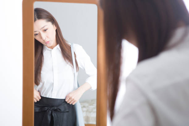 istock Woman looking in the mirror 1082021472