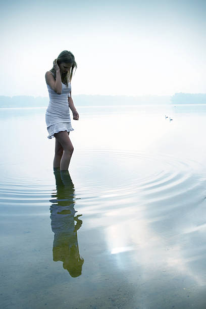 istock Young Woman Walking Through Water 108202181