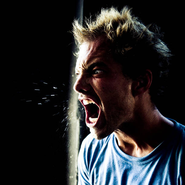 Angry Young Man Yelling and Spitting stock photo