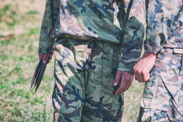 istock Soldier in camouflage holding throwing knives 1082021930