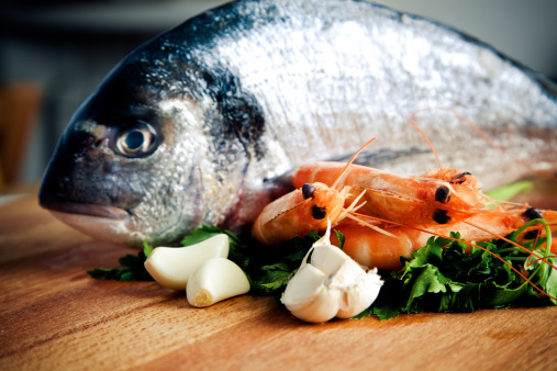 Image of Pile pink cooked shrimp, seafood on white tray, grocery store, meat department