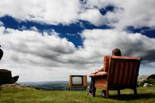 Man watching TV in the great outdoors