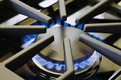 Natural Gas Stove Burner Appliance with Blue Flame Fire Close-up