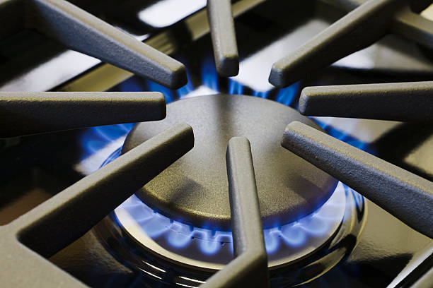 Natural Gas Stove Burner Appliance with Blue Flame Fire Close-up  gas stove burner stock pictures, royalty-free photos & images