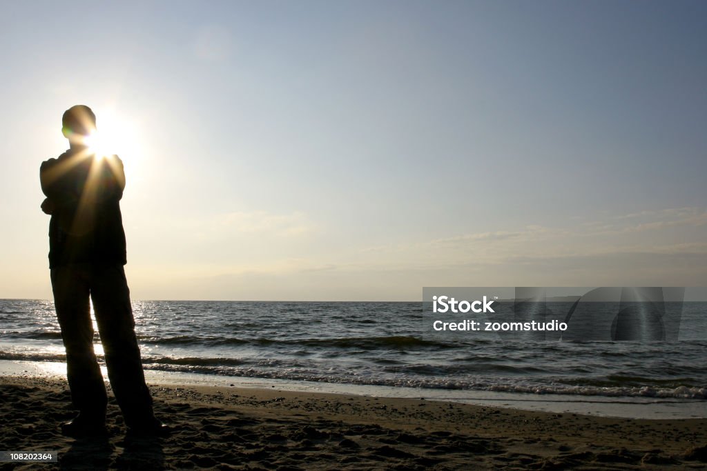 Silueta de hombre de pie en la playa - Foto de stock de Adulto libre de derechos