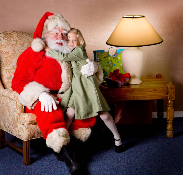 Little Girl Hugging Santa stock photo