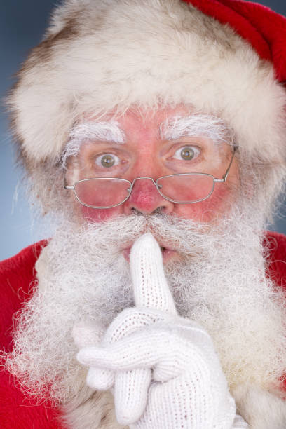 Santa Holding Finger to Lips  bushy stock pictures, royalty-free photos & images