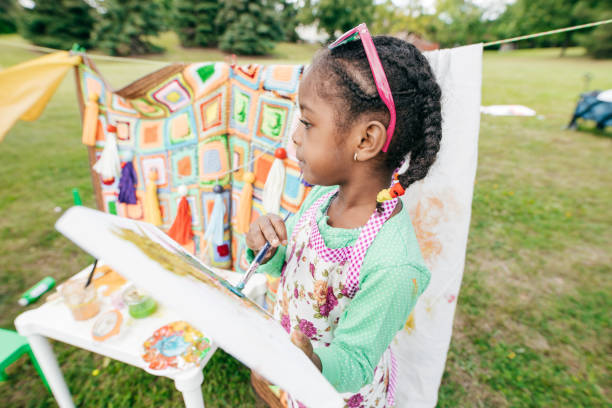 istock Smiling girl with a paintbrush 1082024212