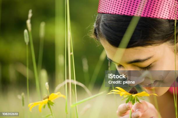 Close Up Of Smiling Teen Girl Smelling A Blackeyed Susan Stock Photo - Download Image Now