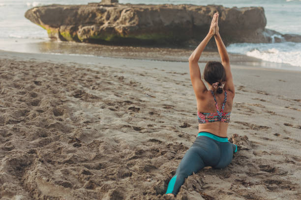 istock Woman doing yoga and stretching exercises 1082028144