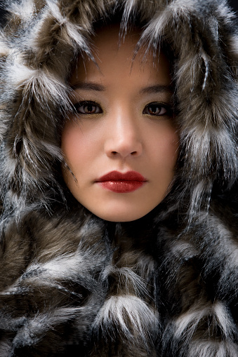Head shot of beautiful Asian girl wrapped in fur. CLICK FOR SIMILAR IMAGES AND LIGHTBOXES WITH MORE BEAUTIFUL WOMEN OR ETHNIC FACES. http://www.quavondo.com/thumbs/IStockLightboxWomen.jpg