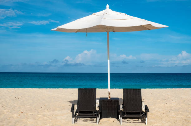 istock Umbrellas and Chairs on a Caribbean Beach on a Sunny Day 1082028980