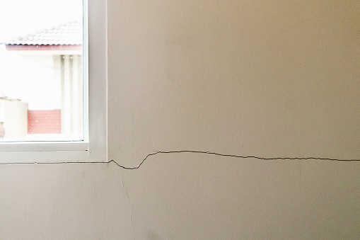 New house wall crack near window frame