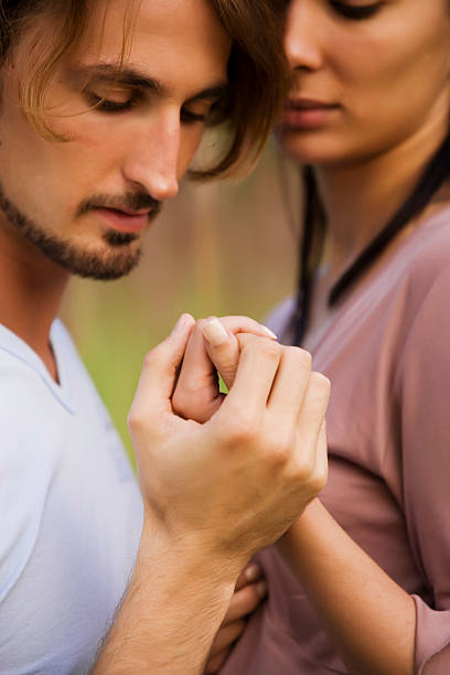 Portrait of Couple Embracing and Holding Hands stock photo