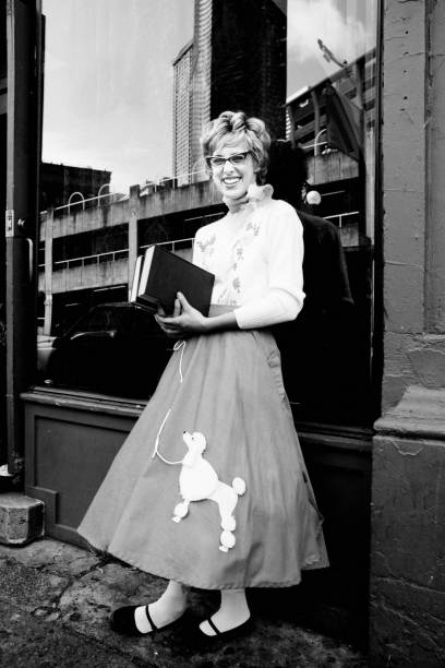 Young Woman Wearing Poodle Skirt and Holding Books stock photo