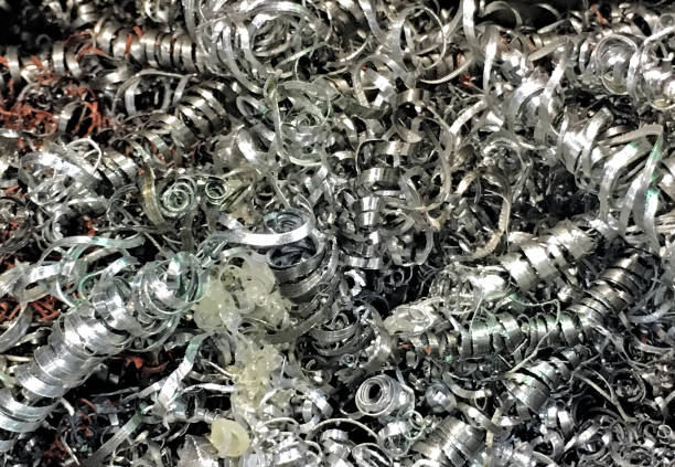 A full frame abstract background of silver colored metal shavings from an industrial workplace.