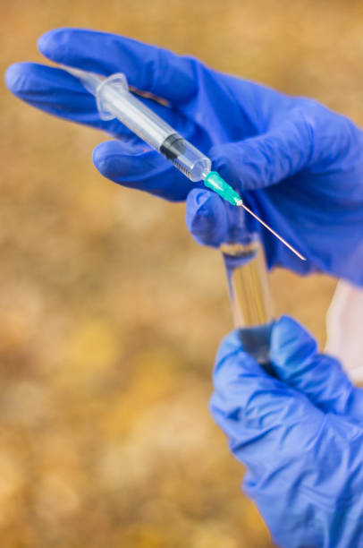 istock Doctor holding medical syringe 1082031158