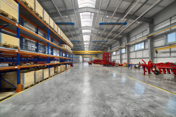 Large, spacious assembly shop. High storage racks with wooden boxes.