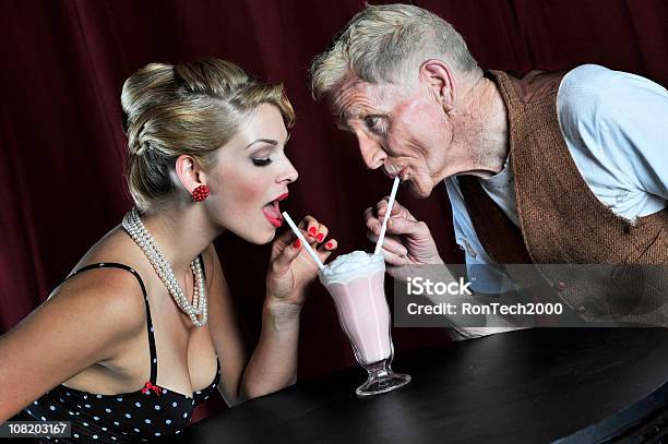 Young Woman And Older Man Sharing A Milkshake Stock Photo - Download Image Now - Senior Men, Gold Digger - Stereotype, Women
