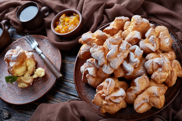 istock Profiterole topped with powdered sugar, dark style 1082031770
