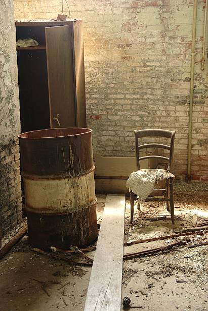 view of a wall of an old abandoned factory building old wooden chair on moldy wall