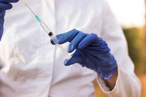 istock Doctor holding medical syringe 1082033206