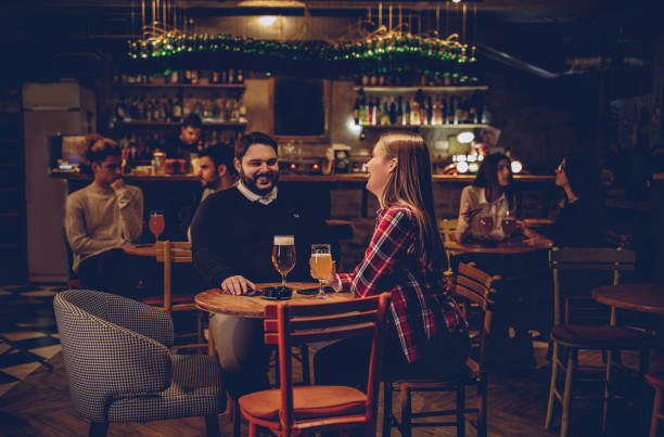 istock Happy couple drinking beer on a date night 1082034076