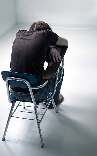 istock Young Man Sitting at School Desk with Head Down 108203479