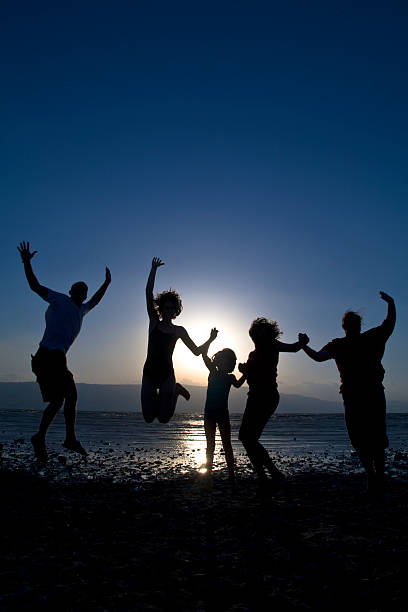 The teenager on sea sand (jumping towards)