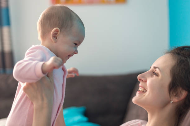 istock mother playing with her baby 1082035792