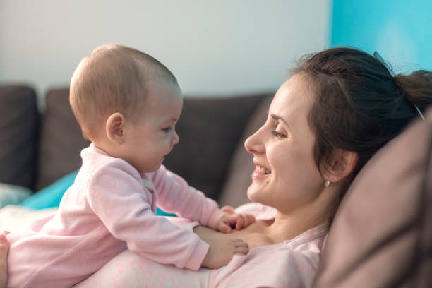 istock mother playing with her baby 1082035864