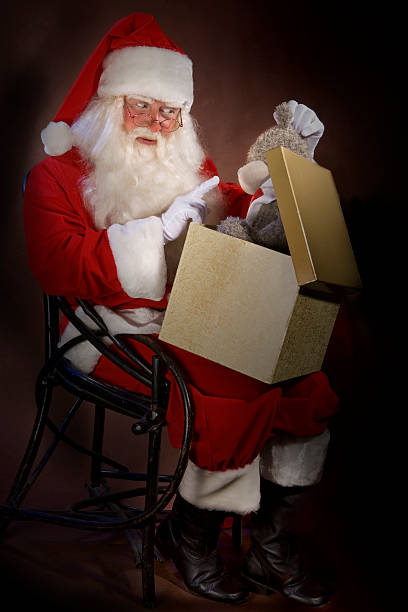 istock Santa Clause Holding Toy and Shaking Finger 108203598
