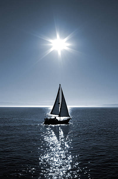 the water reflection of several boats in a sea port
