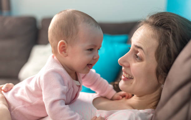 istock mother playing with her baby 1082036176
