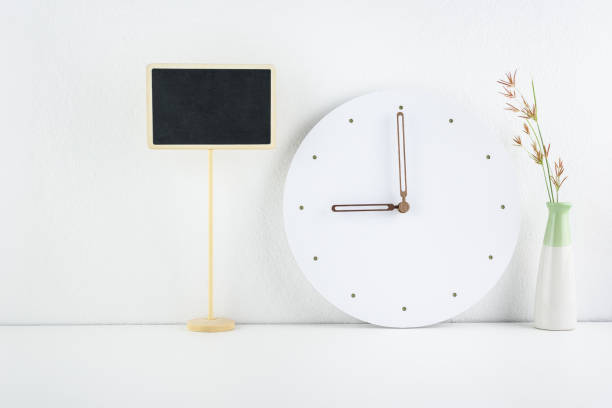 istock Contemporary office desk or workplace concept : Business / personal working space, office supply on table e.g blank / empty chalkboard, analog clock near white wall, clear & clean theme in white toned 1082036204