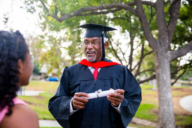 senior hombre negro en la graduación de hablar con su familia - old master fotografías e imágenes de stock