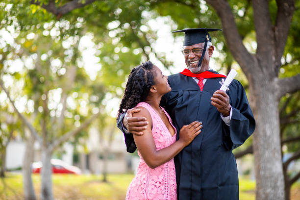 istock Senior black man at graduation with his daughter 1082037928
